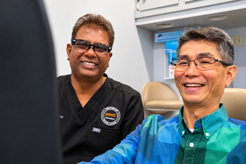Dr. Shankar and patient smiling in the dental chair